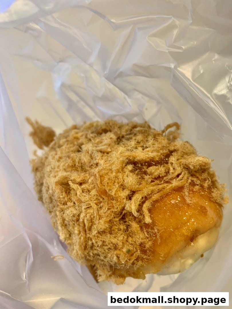 Close-up of a pork floss bun in a clear plastic bag.