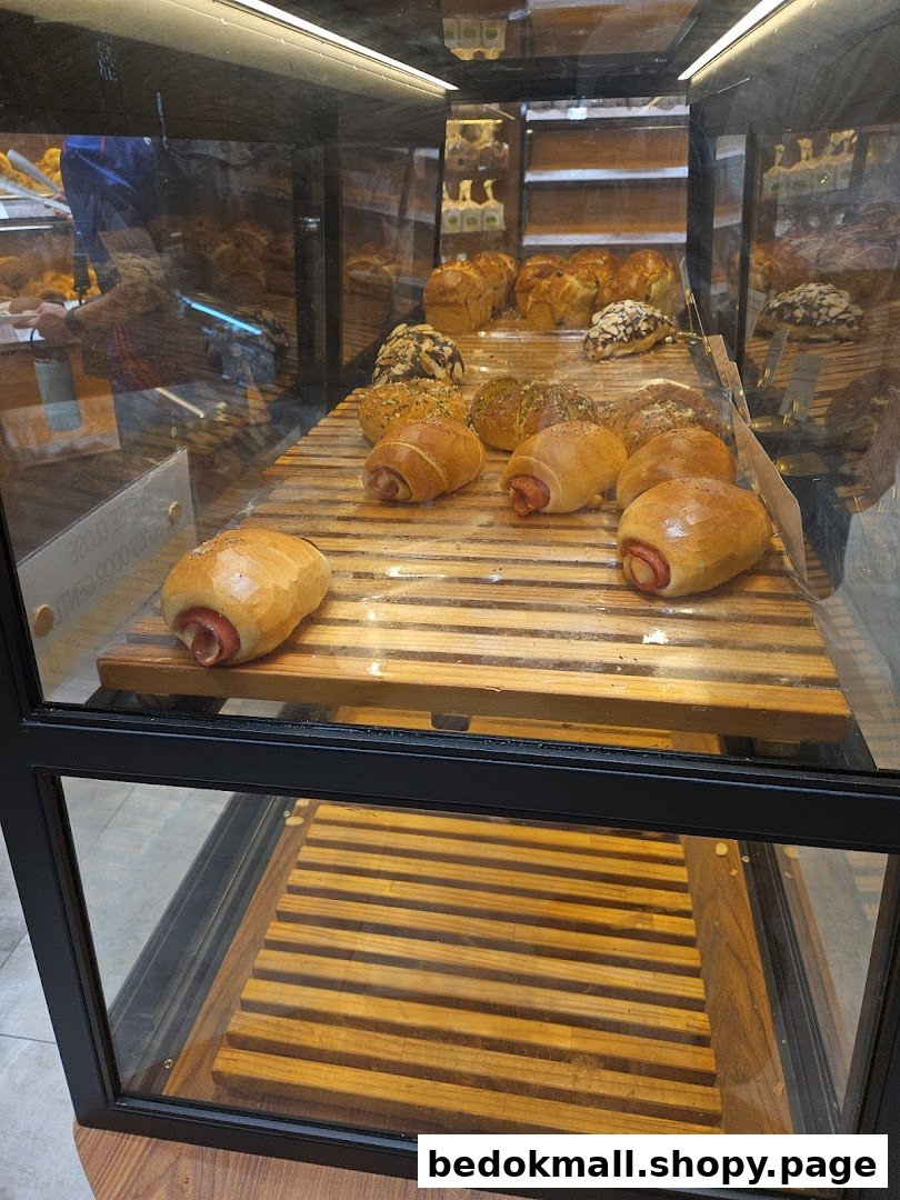 Bakery display case filled with various bread and pastries.