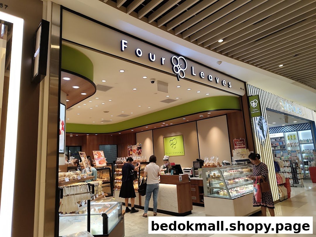 Exterior view of Four Leaves bakery with customers and display cases.
