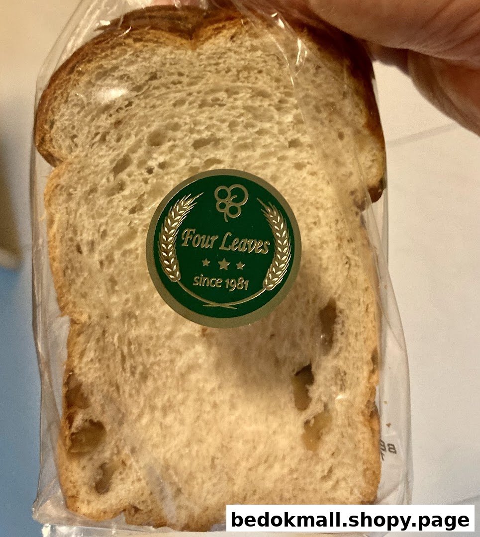 A slice of bread in plastic packaging with a 'Four Leaves' label.