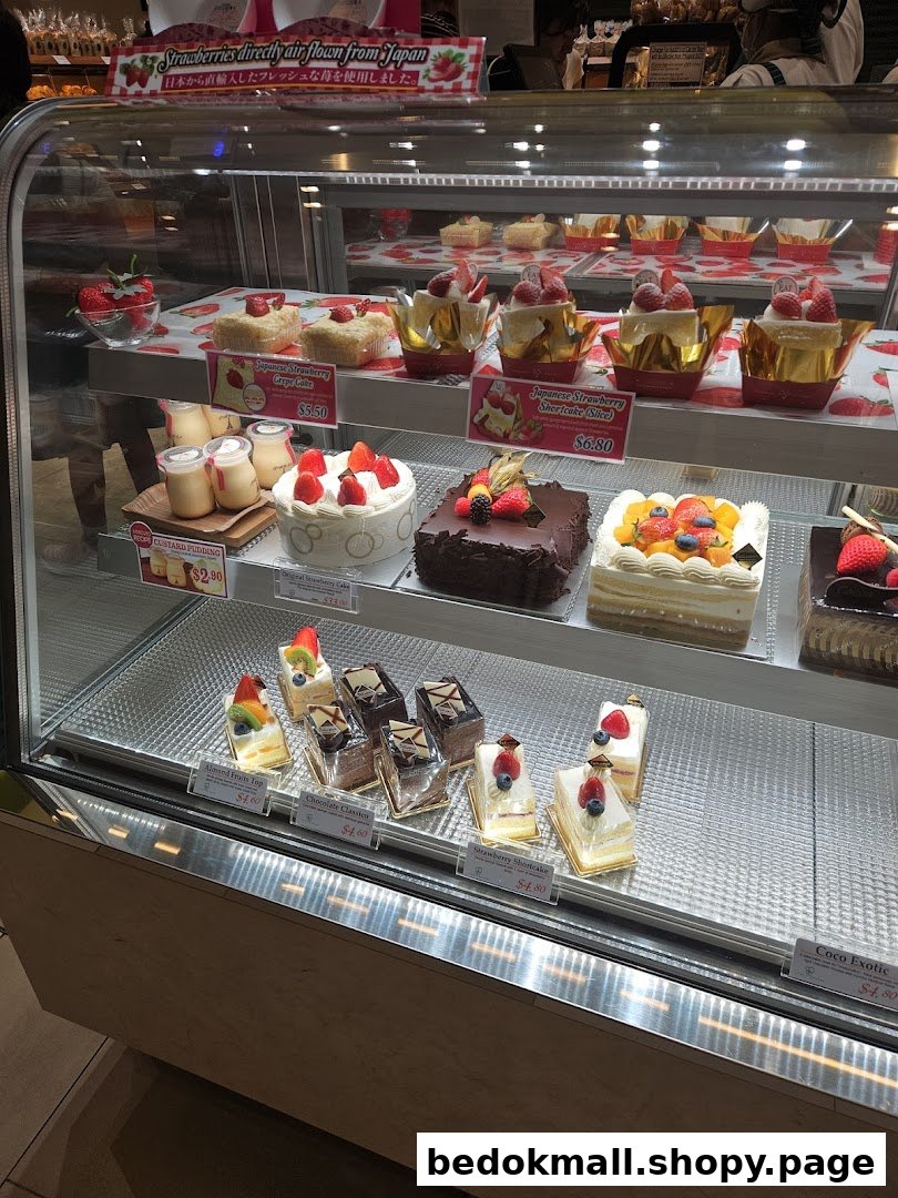 Glass display case showcasing a variety of delicious cakes and desserts.