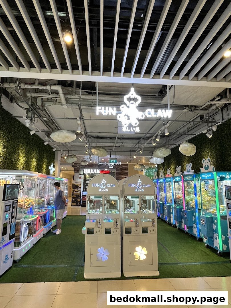 Interior of Fun Claw arcade with numerous claw machines and a person.