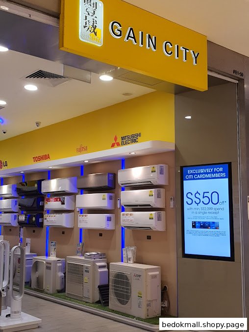 Interior view of an electronics store displaying air conditioners and appliances.