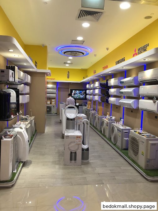 Interior of an electronics store displaying numerous air conditioners and appliances.