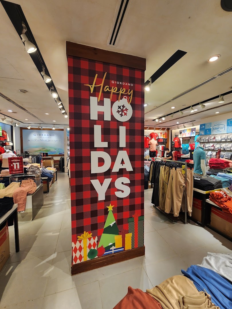 Interior view of a Giordano clothing store with holiday decorations and merchandise.