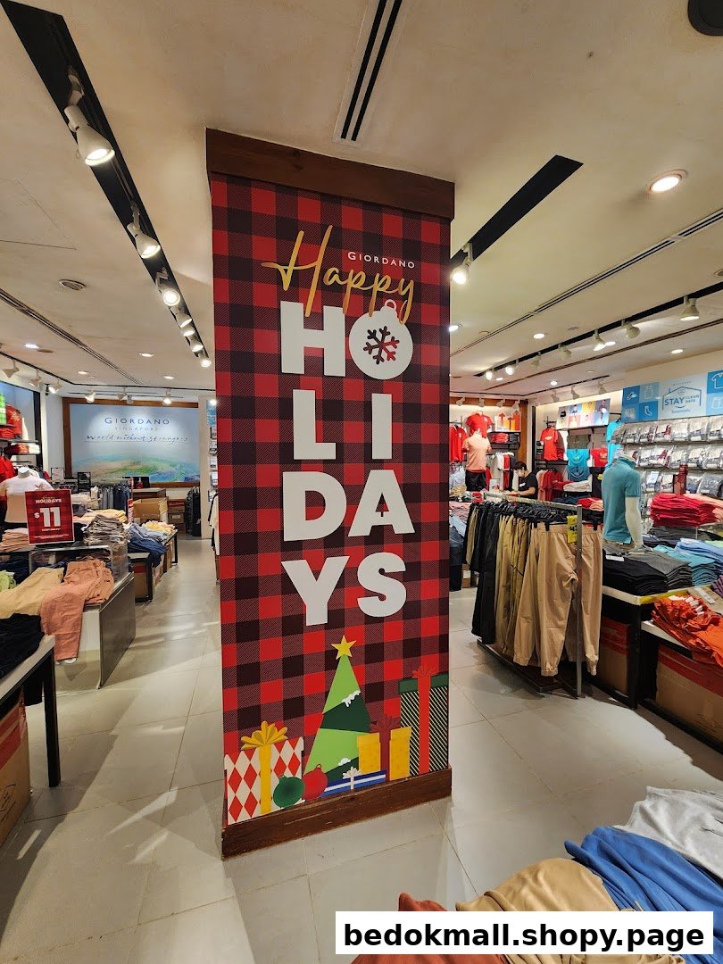 Interior view of a Giordano clothing store with holiday decorations and merchandise.