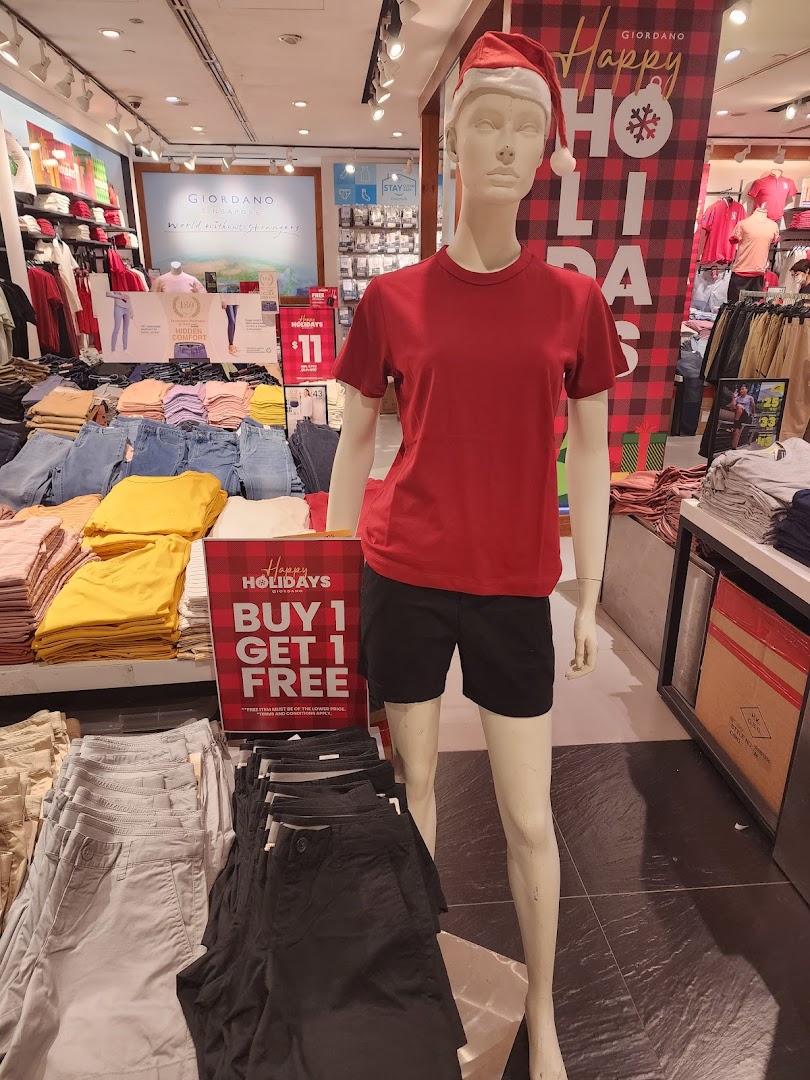 Mannequin and folded clothes inside a Giordano retail store.