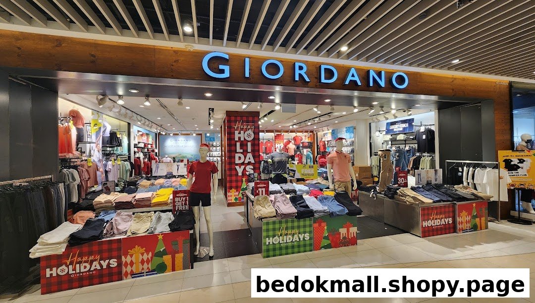 The storefront of Giordano, a clothing shop, with holiday decorations and mannequins.