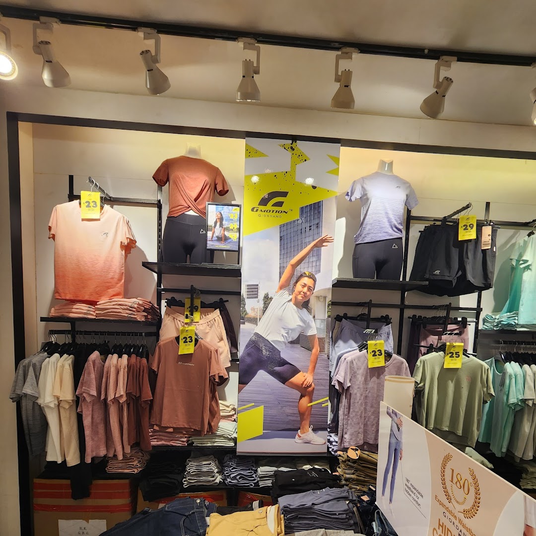 Interior shop display of activewear clothing on mannequins and shelves.