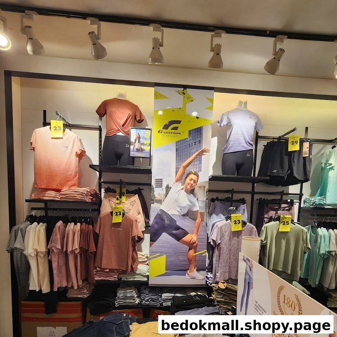 Interior shop display of activewear clothing on mannequins and shelves.