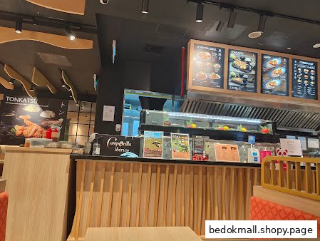 Restaurant interior showing a counter, menu boards, and seating area.