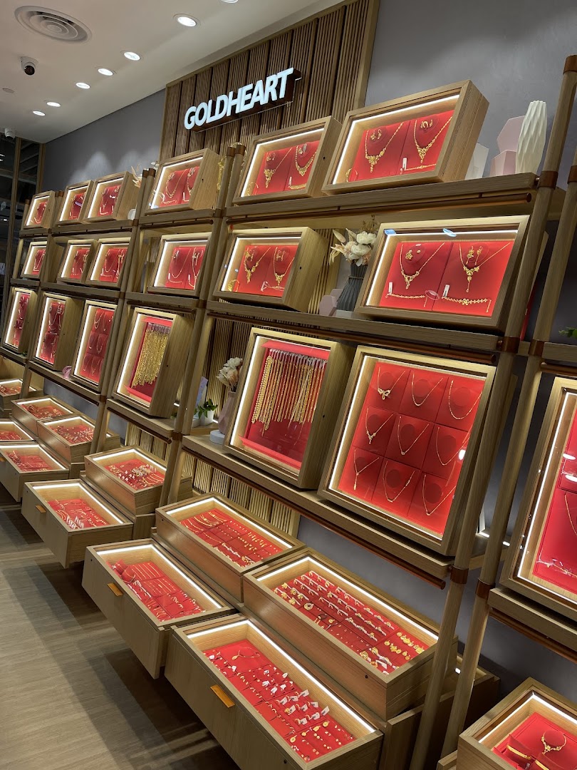 Interior view of a jewelry shop with multiple display cases of gold jewelry.