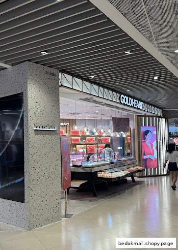 View of Goldheart Jewelry shop entrance with display cases and signage.