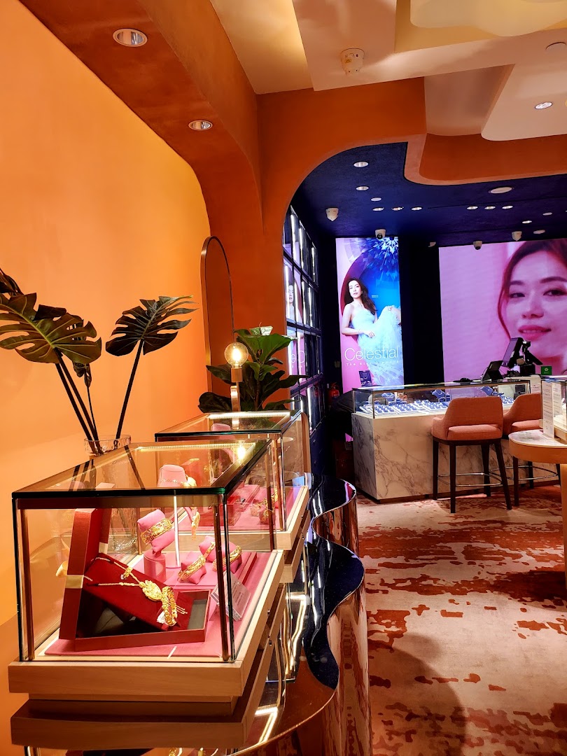 Interior view of a jewelry shop with display cases and large screens.
