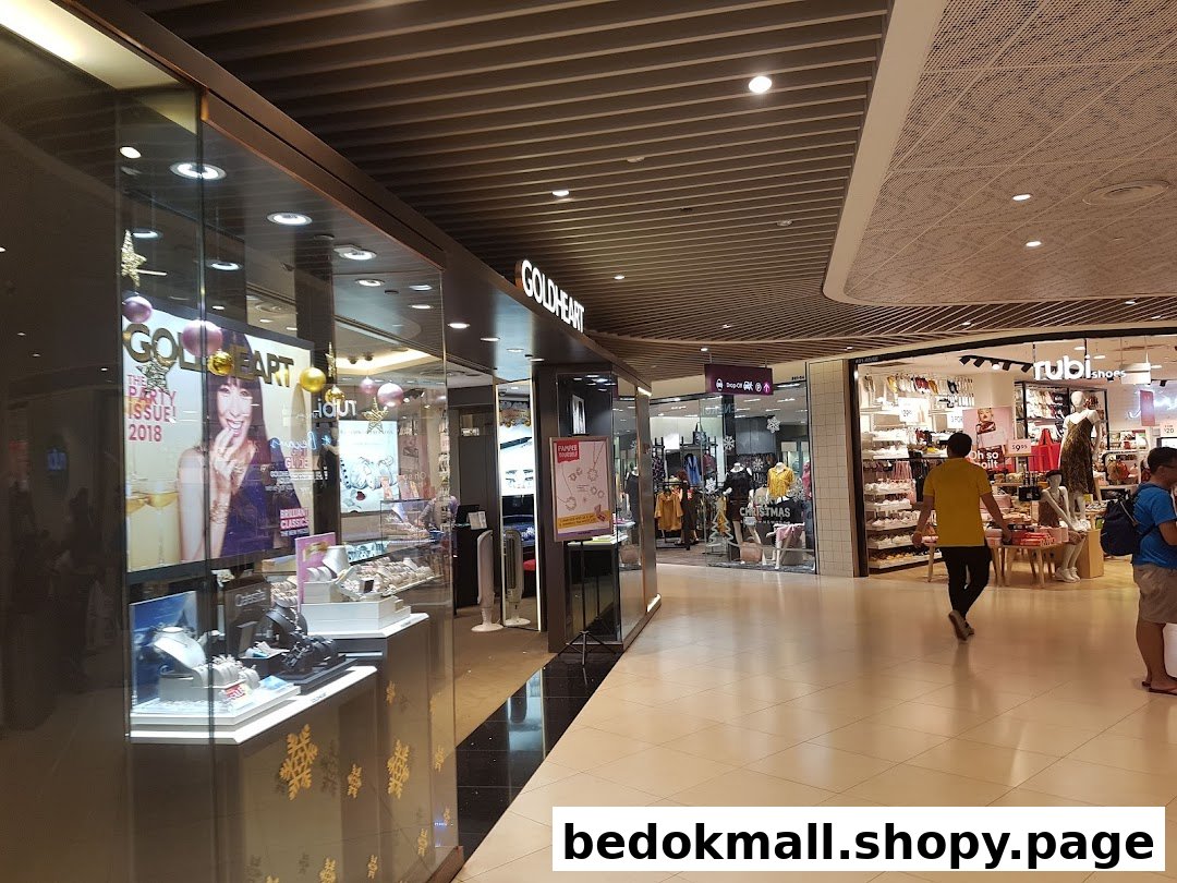 Goldheart Jewelry shop front with displays and mall corridor.