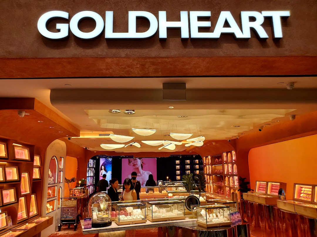 Interior view of a Goldheart jewelry store with display cases and customers.