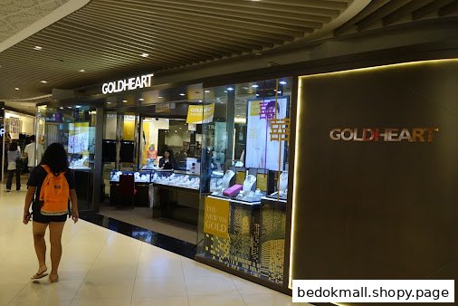 Exterior view of Goldheart jewelry shop in a mall with display windows.
