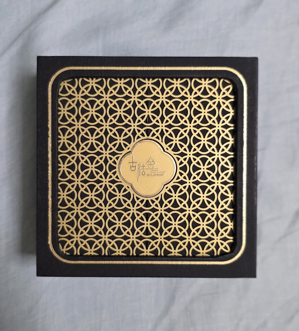 A black box with a gold patterned lid and Goldheart logo.