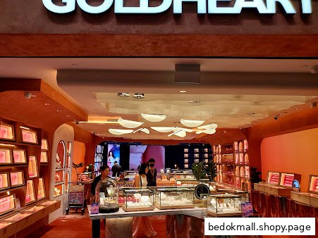 Interior view of a Goldheart Jewelry store with display cases and customers.