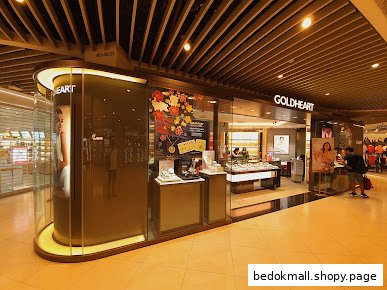 Exterior view of Goldheart jewelry shop in a mall with display windows.