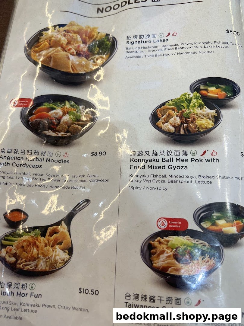 A close-up of a food menu displaying various noodle dishes with prices.
