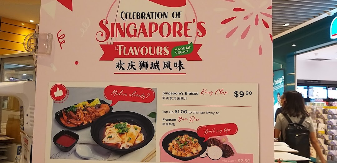 Large menu board displaying Singaporean food items and prices.