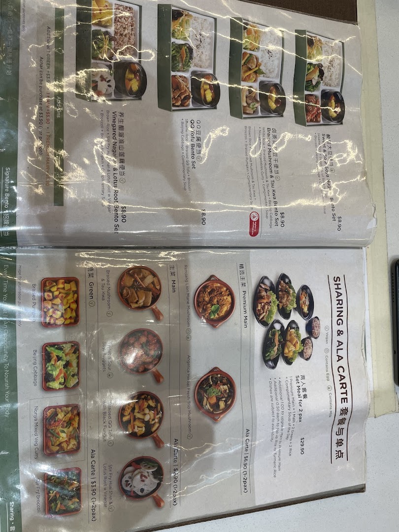 A close-up view of a laminated menu displaying food items and prices.