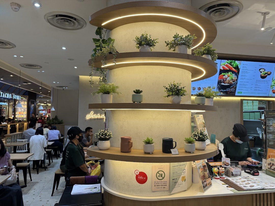 Interior view of a restaurant with customers, counter, and decorative pillar.