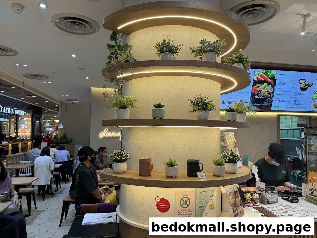 Interior view of a restaurant with customers, counter, and decorative pillar.