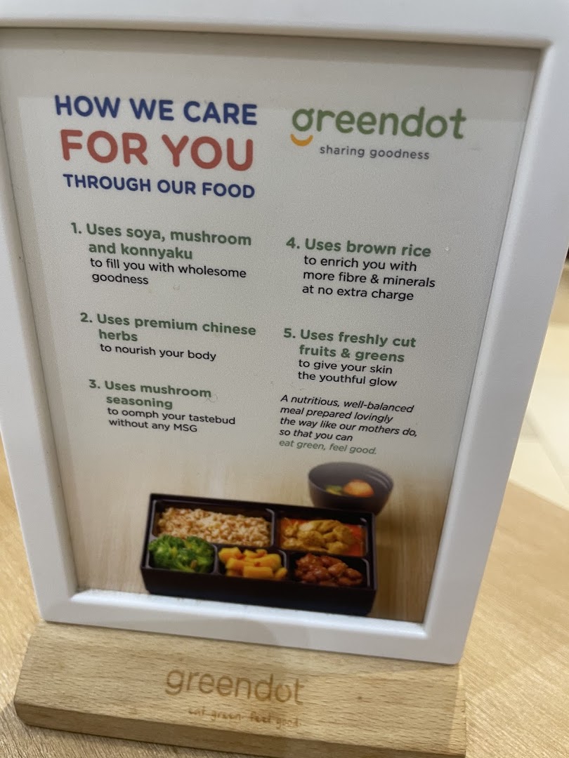 Informational display about Greendot's food philosophy with a meal image.