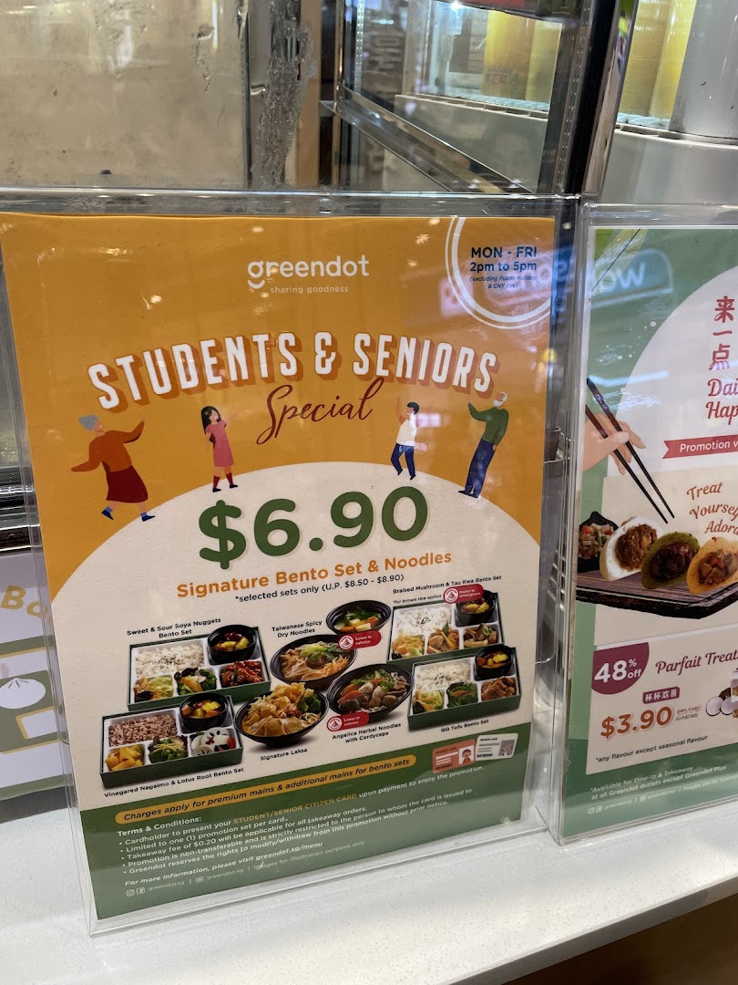 A promotional display for Greendot's Students & Seniors Special on bento sets and noodles.