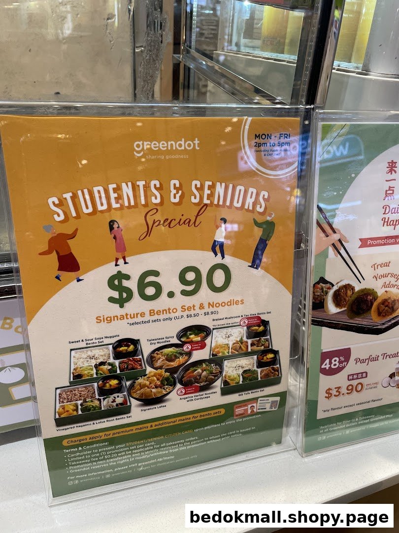 A promotional display for Greendot's Students & Seniors Special on bento sets and noodles.