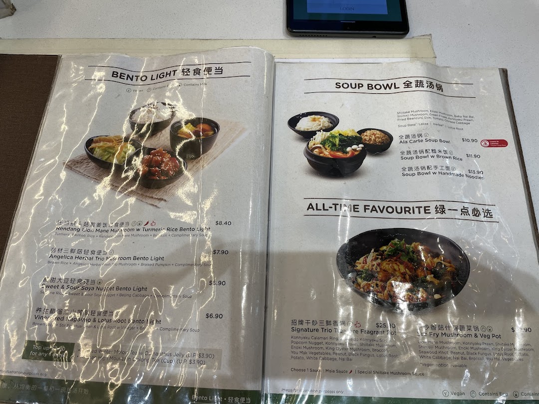Laminated menu displaying various food items, descriptions, and prices.