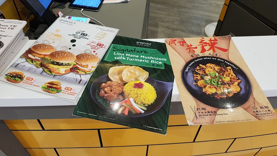 Three menus displaying various food items and prices on a counter.