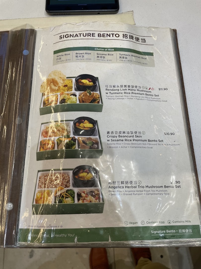 A close-up of a menu displaying various bento sets with prices.