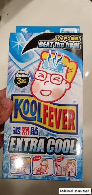 Hand holding a box of KoolFever Extra Cool cooling patches.