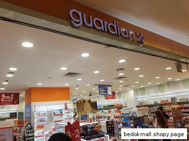Entrance of a Guardian health and beauty store with products visible inside.