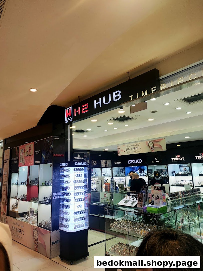 Interior view of a watch shop with display cases and staff.