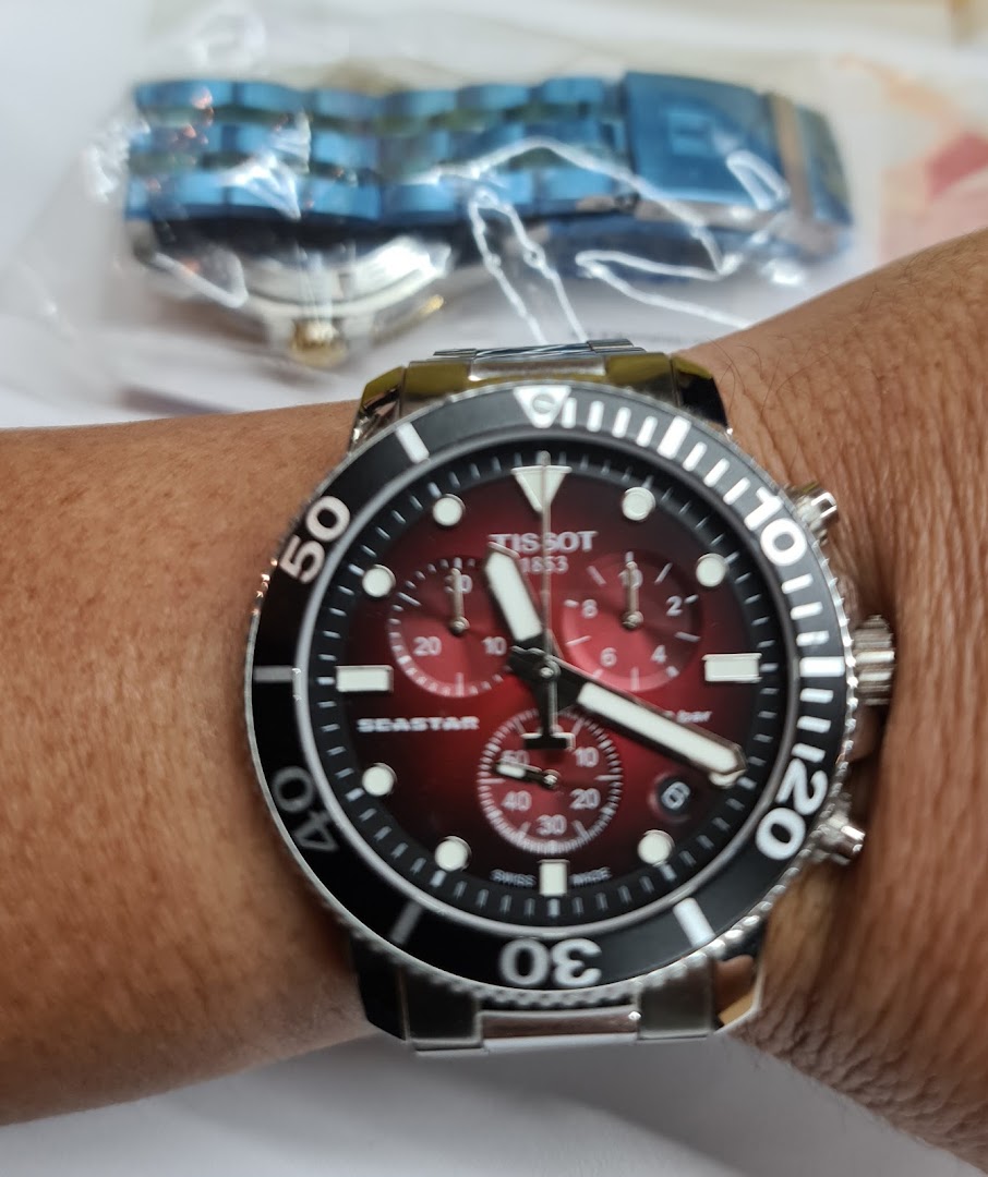 Close-up of a Tissot watch on a person's wrist.