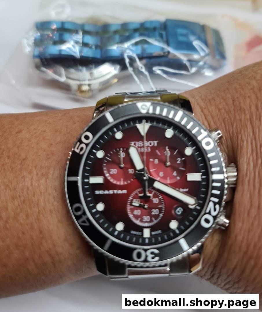 Close-up of a Tissot watch on a person's wrist.