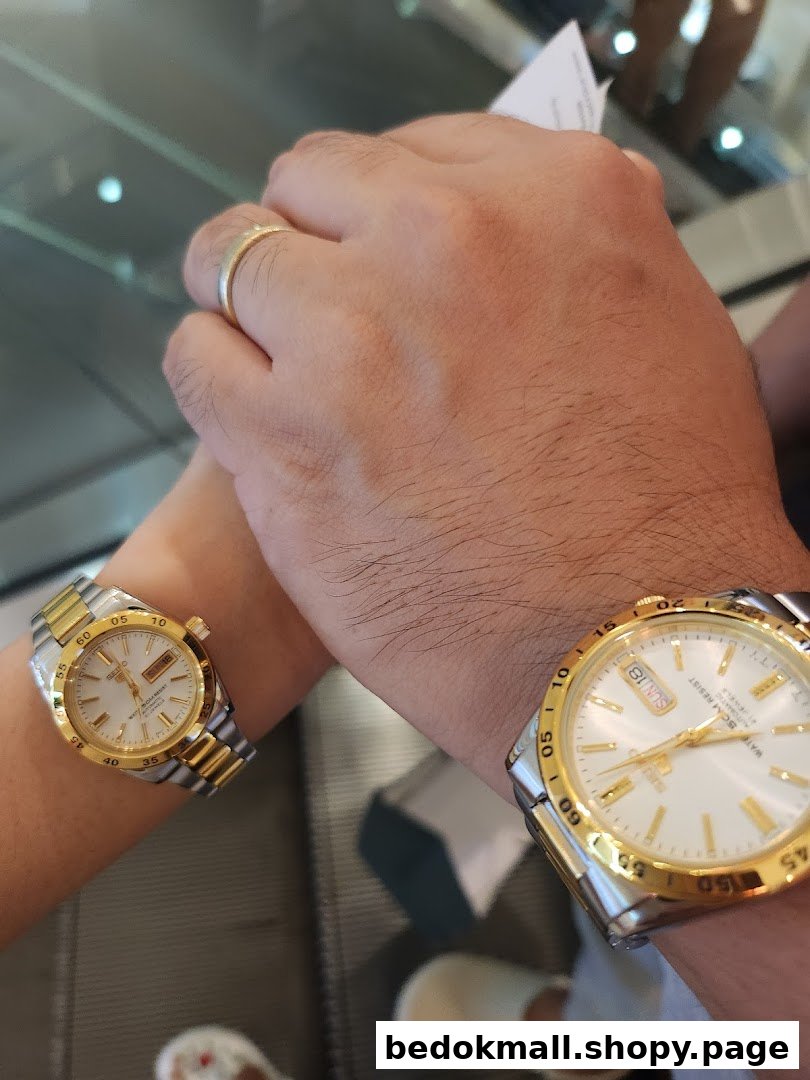 Two people wearing gold and silver watches on their wrists.