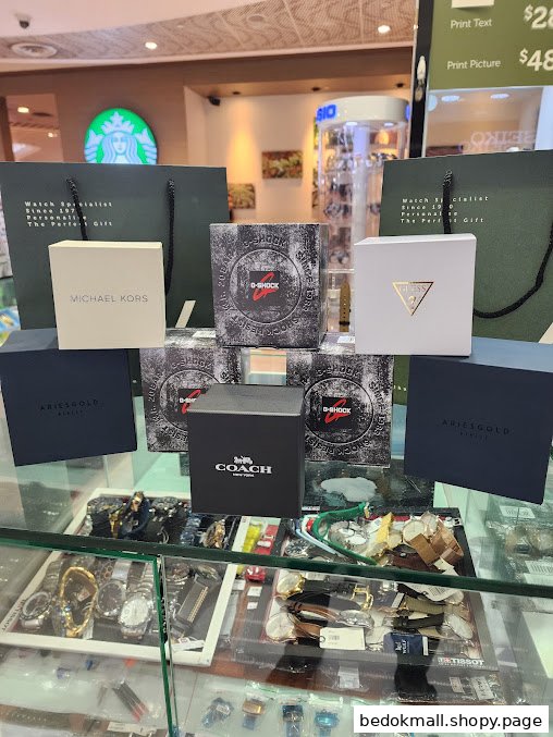 Branded watch boxes and bags displayed on a counter inside a retail shop.