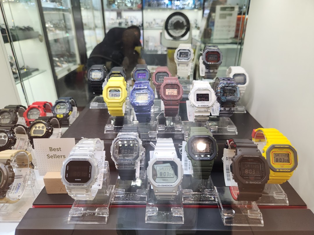 A display case filled with various colorful G-Shock watches.
