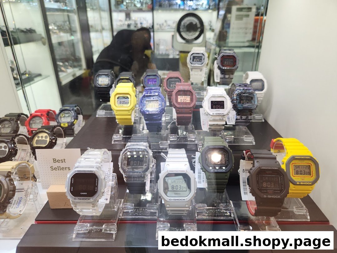 A display case filled with various colorful G-Shock watches.