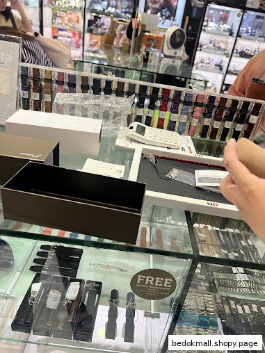 Interior view of a watch shop counter with various watch straps and boxes.