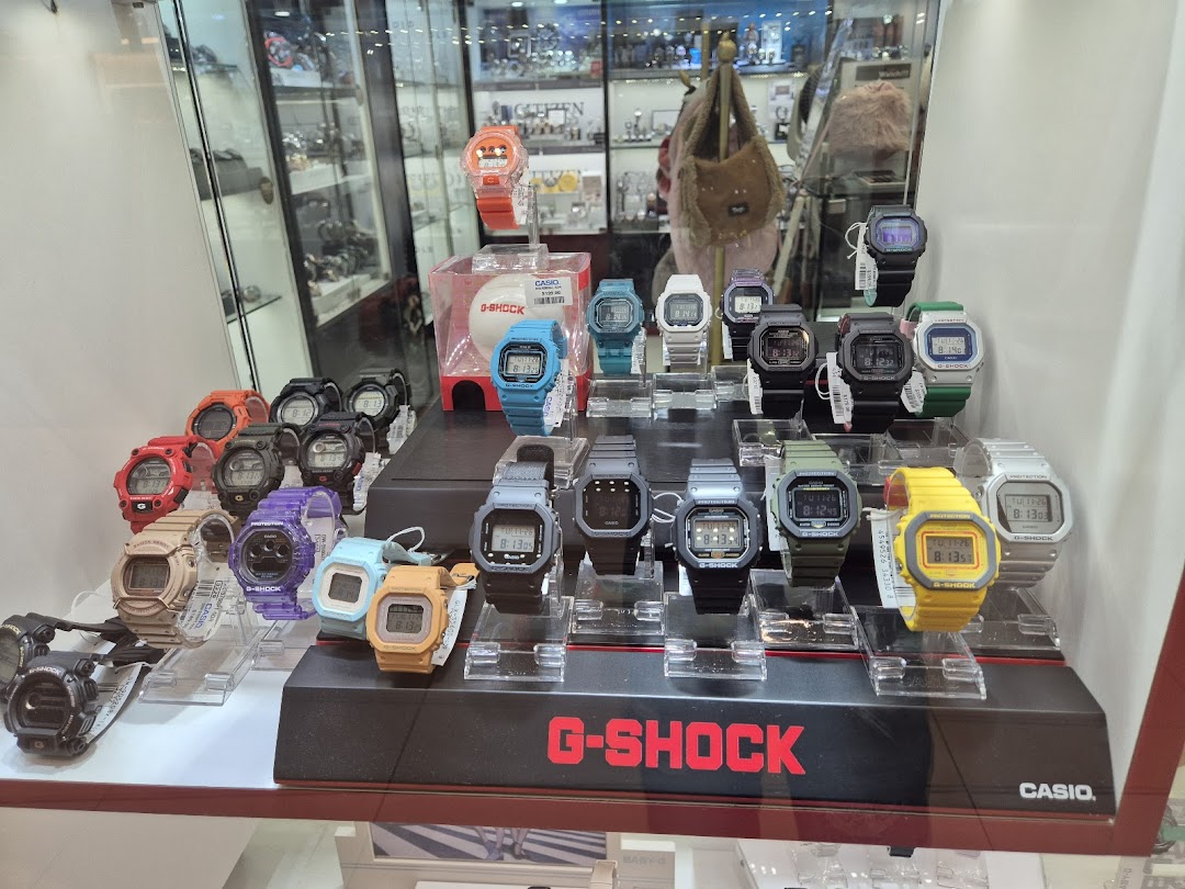 A display of colorful G-Shock watches inside a retail store.