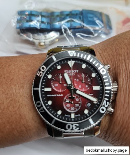 A Tissot Seastar watch is worn on a person's wrist.