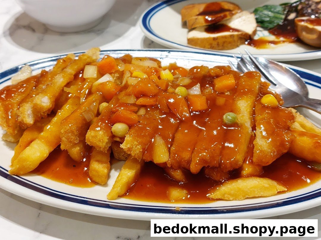 A plate of fried cutlets and fries with sweet and sour sauce.