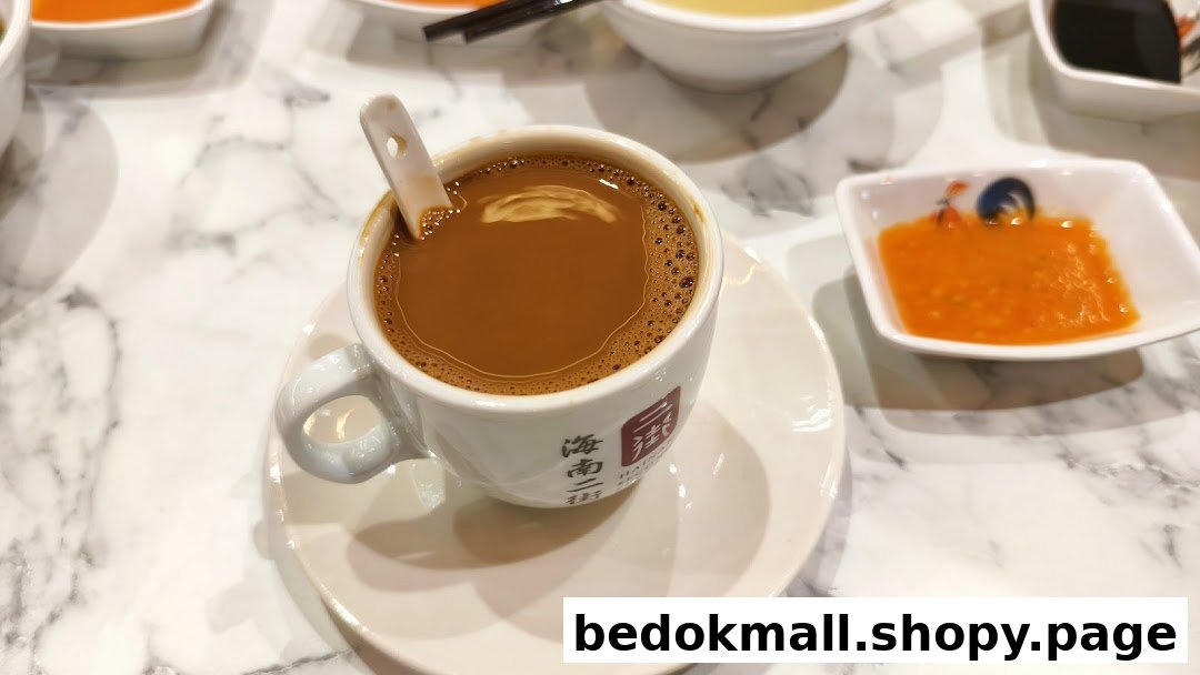 A cup of coffee/tea on a marble table with sauces.