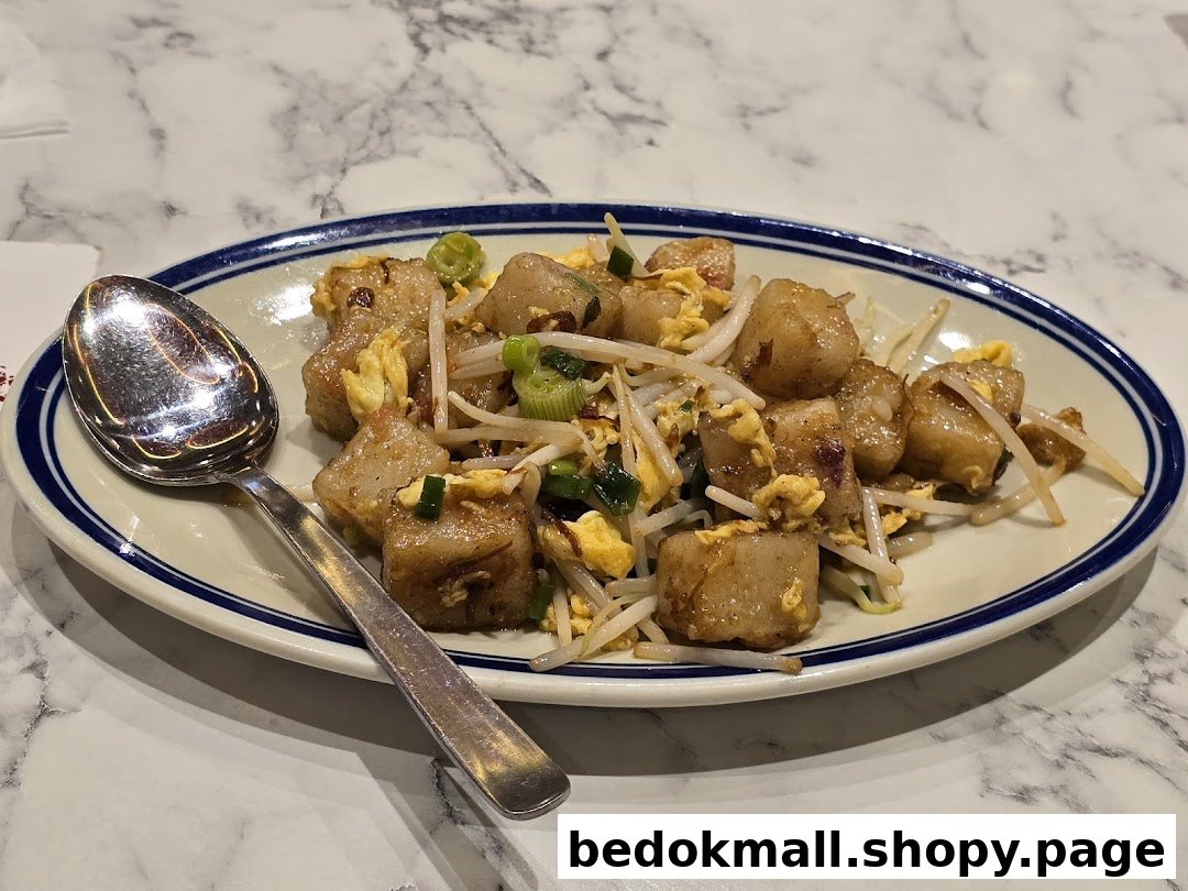A plate of fried radish cake with bean sprouts and egg on a marble table.
